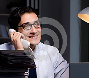 Young businessman working overtime late in office