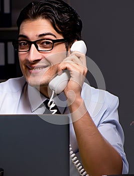 Young businessman working overtime late in office