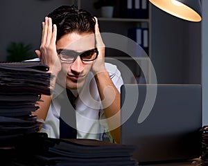 Young businessman working overtime late in office