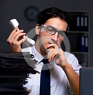 Young businessman working overtime late in office