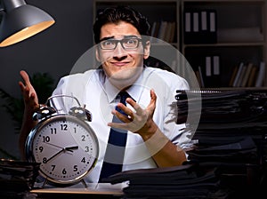 Young businessman working overtime late in office