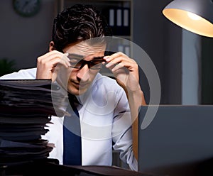 Young businessman working overtime late in office