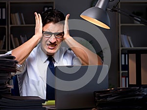 Young businessman working overtime late in office