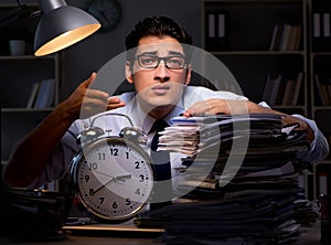 Young businessman working overtime late in office