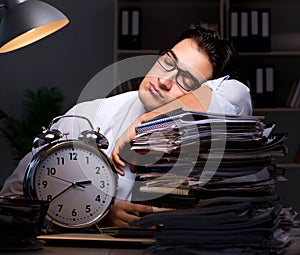 Young businessman working overtime late in office