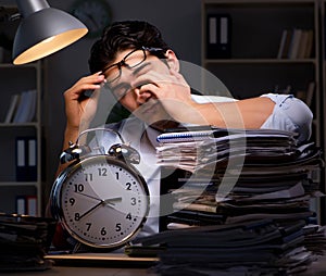 Young businessman working overtime late in office