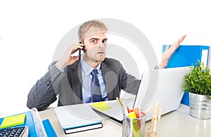 Young businessman worried tired talking on mobile phone in office suffering stress