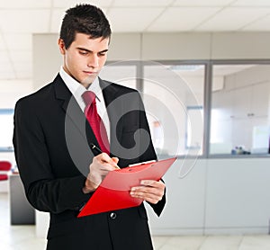 Young businessman writing