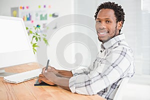 Young businessman writing on the graphic tablet