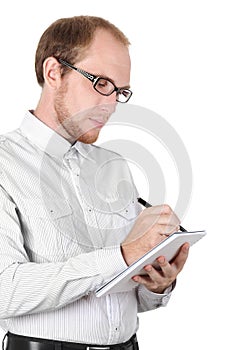 Young businessman writing in notebook