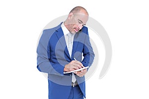 Young businessman writing on a notepad