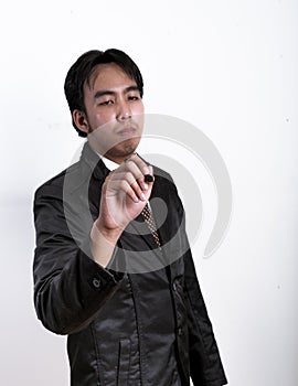 Young businessman writing on transparent screen over white background..