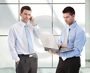 Young businessmen in office lobby