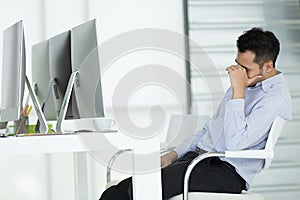 Young businessmen in stress. Sit in front of modern office computer, concept for hard work in an organization.