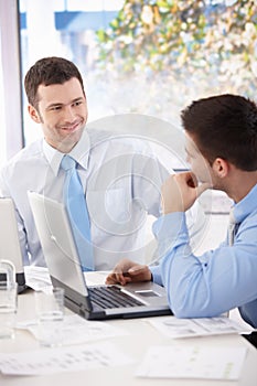 Young businessmen talking at meeting table