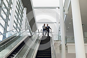 Young businessmen at the top of an escalator