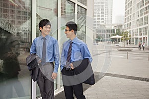 Young businessmen walking outside of the office