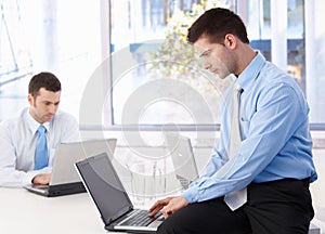 Young businessmen working on laptop