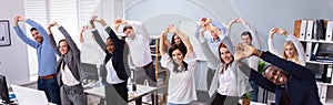 Young Office Workers Doing Stretching Exercise At Workplace photo