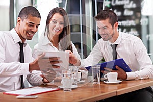 Young businesspeople having a business meeting at coffee shop