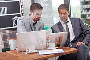 Young businesspeople having a business meeting at coffee shop