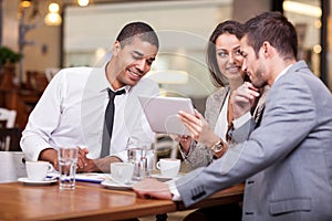 Young businesspeople having a business meeting at coffee shop
