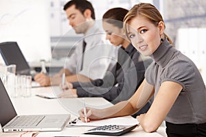 Young businesspeople sitting at meeting table