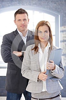 Young businesspeople standing in office