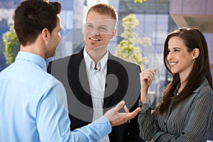 Young businesspeople talking outside of office