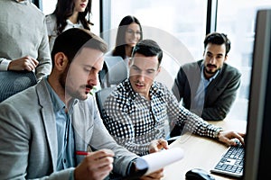 Young businesspeople working on computer in office