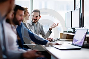 Young businesspeople working on computer in office