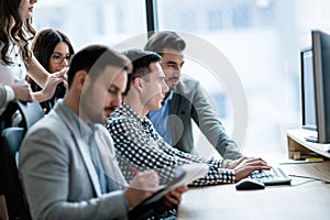 Young businesspeople working on computer in office