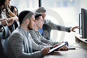 Young businesspeople working on computer in office