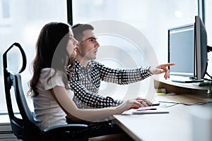 Young businesspeople working on computer in office