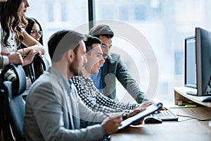 Young businesspeople working on computer in office