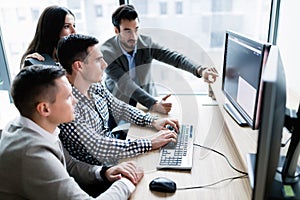 Young businesspeople working on computer in office