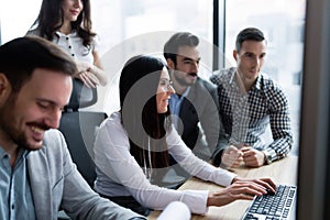 Young businesspeople working on computer in office