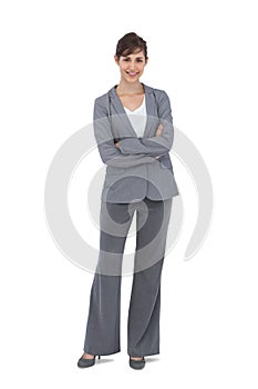 Young businesswoman with arms crossed smiling at camera