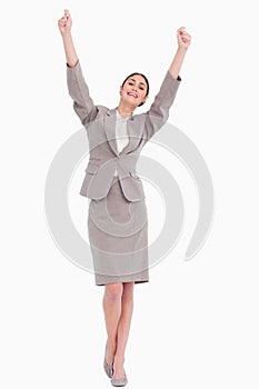 Young businesswoman with arms raised
