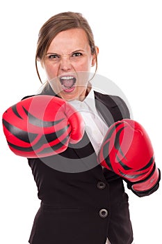 Young businesswoman with boxing gloves punching ready to fight,