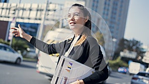 Young businesswoman calls a taxi