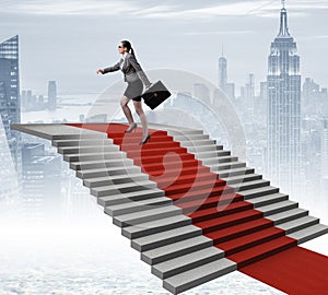 Young businesswoman climbing stairs and red carpet