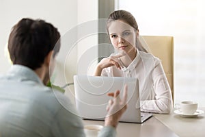 Young businesswoman conducting job interview or talking to busin