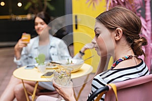 Young businesswoman drinking cold water with lemon