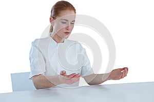 Young businesswoman examining imaginary product