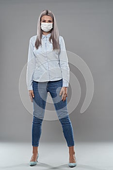 Young businesswoman in face mask, full length portrait