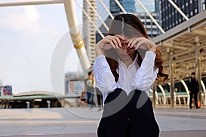 Young businesswoman feeling failure and frustrated with her work. Stressed business concept. Selective focus and shallow depth of