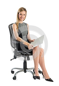 Young Businesswoman With File Sitting On Office Chair