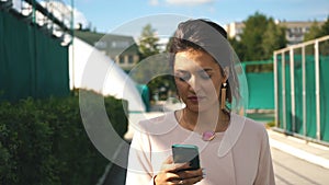 Young businesswoman goes and uses the phone