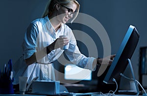 Young businesswoman having coffee break at work